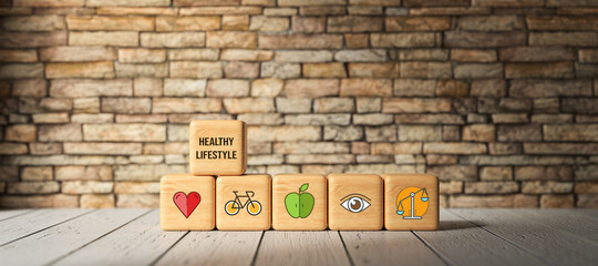 Fototapeta na wymiar cubes with healthcare symbols and message HEALTHY LIFESTYLE in front of a brick wall