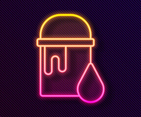 Glowing neon line Paint bucket icon isolated on black background. Vector