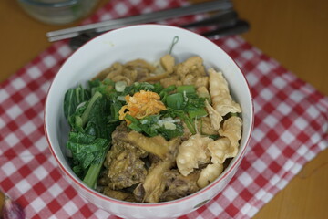 Mie Ayam or chicken noodle, Indonesian cuisine. Yellow wheat noodle topped with chicken meat, mushroom, bok choy. Served with fried wonton, scallion and fried shallot.