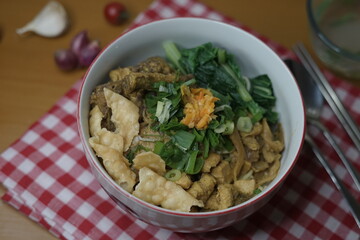 Indonesian food, Mie Ayam or Bami ayam, noodles with chicken and served and deep-fried wonton pangsit