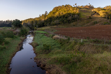Farm fields with stream plantation and forest