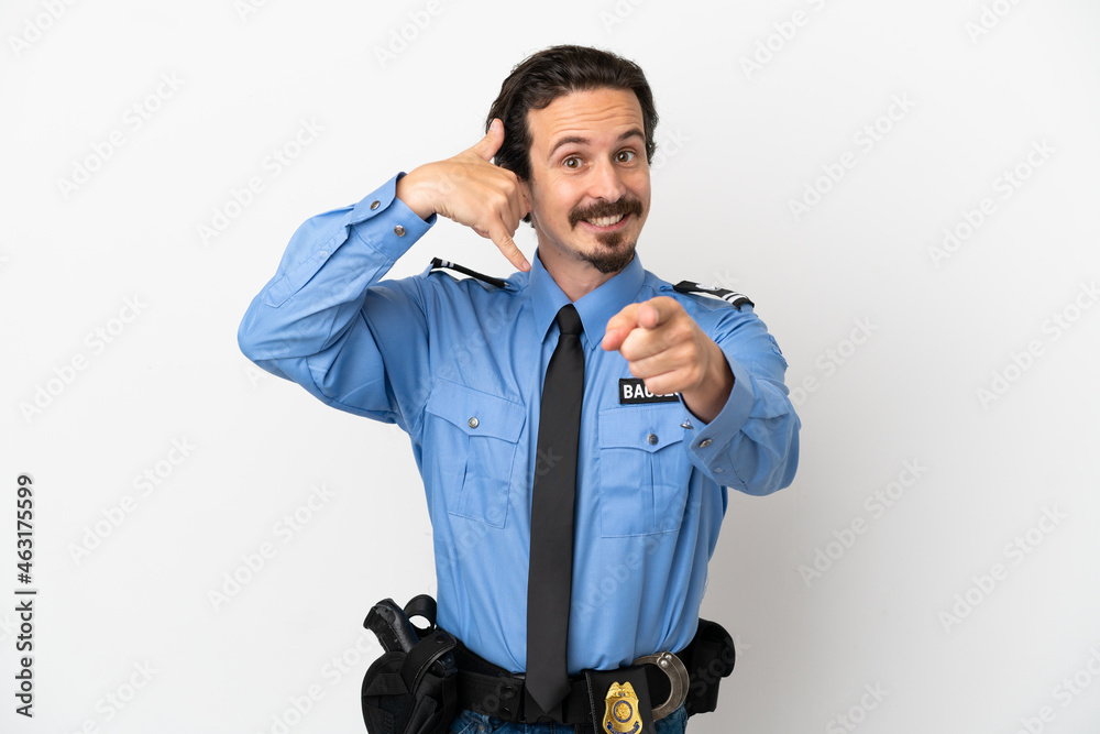 Wall mural Young police man over isolated background white making phone gesture and pointing front