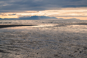 Sunset over the Isle of Arran, seen from the beach in Irvine, Scotland.
