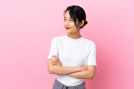 Young Vietnamese Woman Isolated On Pink Background Looking To The Side