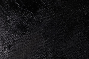 Dark creative background - rough linen canvas unevenly covered with black primer, reflections of...