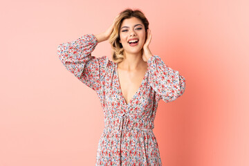 Obraz premium Young Russian woman isolated on pink background laughing