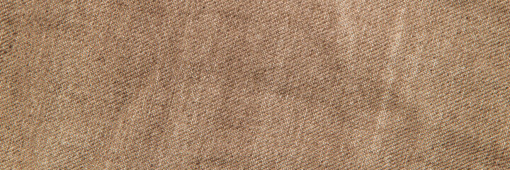 fabric grunge background, real cotton denim brown, wrinkled, frayed, close