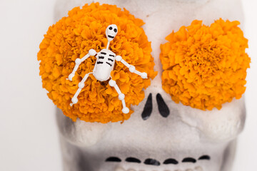 Day of the dead decoration, mini comic skulls with cempasuchil flowers, party invitation, copy space.