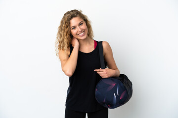 Young sport woman with sport bag isolated on white background laughing