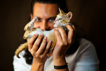 Man is happy to adopt a kitten 