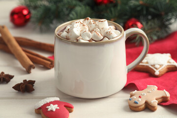 Delicious hot chocolate with marshmallows and Christmas cookies on white wooden table, closeup