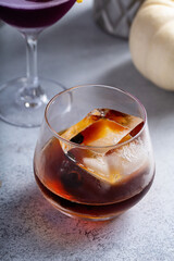 Fall cocktails, old fashioned in a glass with ice cube