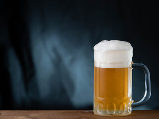glass of beer on wooden table
