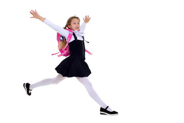 Obraz premium Smiling schoolgirl happily jumping high