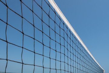 Fototapeta na wymiar Beach volleyball court with an ocean background. Summer sport concept