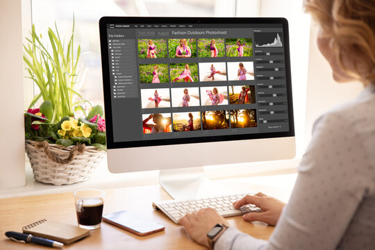 Woman editing digital photos on desktop computer