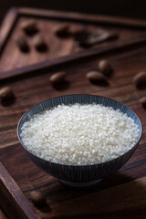 A bowl of rice on wooden table.