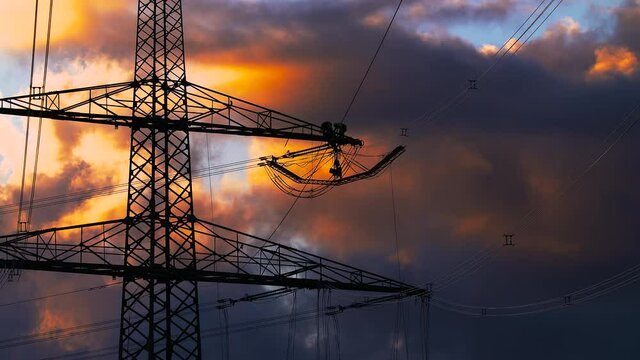 Work on high-voltage lines during sunset 