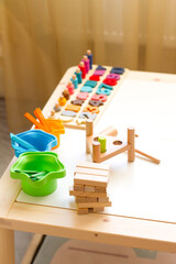 Wooden toys for an early age. Educational logic games: hammer, numbers, color sorting. Montessori child development material. . School and kindergarten.