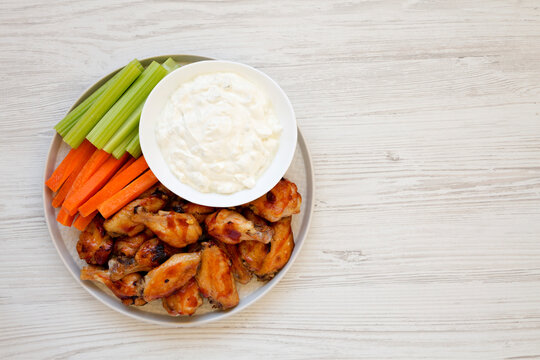 Homemade Chicken Wings With Blue Cheese Dip On A White Wooden Background, Top View. Flat Lay, Overhead, From Above. Space For Text.