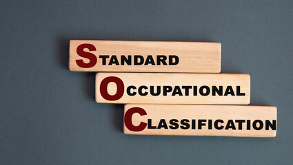 SOC - acronym on wooden bars on a gray background