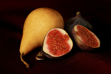 pear and figs lie on a black background