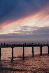 Fototapeta na wymiar lilac sunset over the sea, promenade, pier