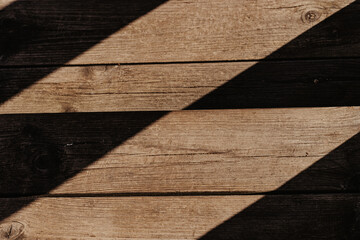 Abstract wooden background with hard shadows.
