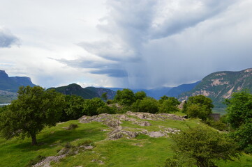 Beautiful landscape at Castelfeder heavy clouds and mountains behind 