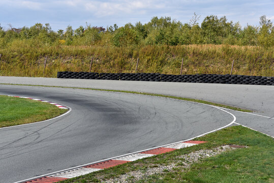 Shot of empty auto racing racetrack turn. Motor racing track. Turning asphalt road with marking lines