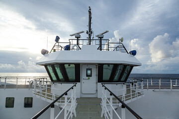 Top of the vessel with bridge, navigation lights and radars, outside view.