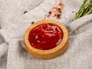 Tomato sauce in the wooden bowl