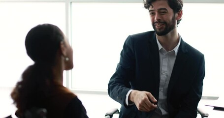 Success business deal handshake shot, Caucasian man and Latin America woman finished agreement negotiation with good result and shaking hands with happy and feeling of long term strong relationship.