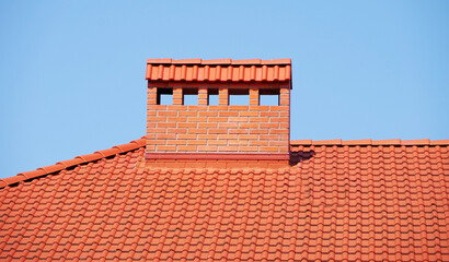 roof of the house is made of red tiles