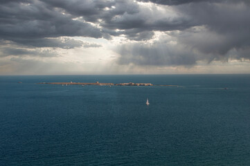 Fototapeta premium View of the island of Tabarca with storm clouds, from the lighthouse of Santa Pola, ALicante, Spain