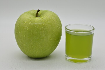 Apples and apple juice against a white background.