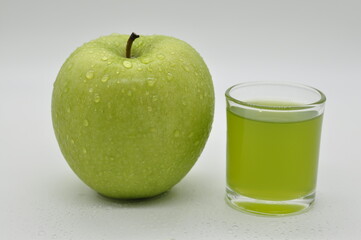 Apples and apple juice against a white background.