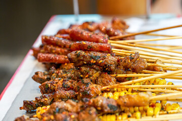 A plate of grilled skewers with rich ingredients