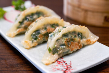 A plate of delicious Chinese fried leek dumplings