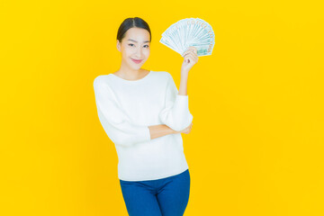 Portrait beautiful young asian woman smile with a lot of cash and money