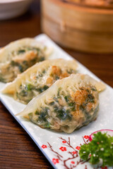 A plate of delicious Chinese fried leek dumplings