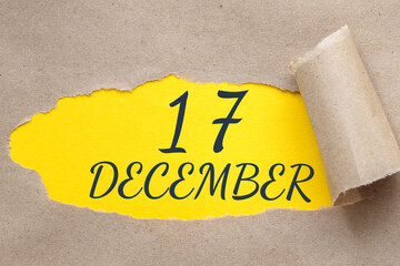 december 17. 17th day of the month, calendar date.Hole in paper with edges torn off. Yellow...