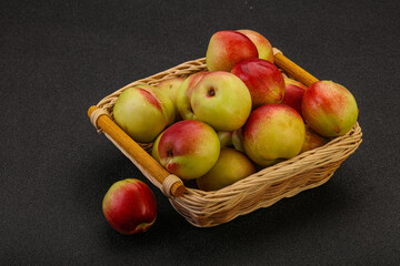 Sweet small nectarines in the basket