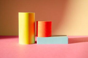 Bright minimalistic abstract background with three-dimensional geometric shapes: cylinders, rectangular podium. podiums for goods. Selective focus, Space for text