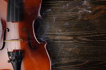 Fototapeta premium Violin on brown wooden table.