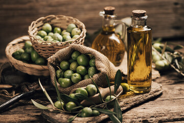 Green olives and olive oil in a bottle