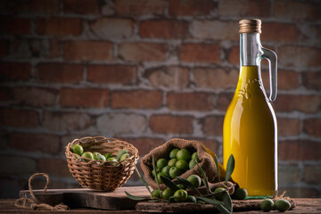 Green olives and olive oil in a bottle