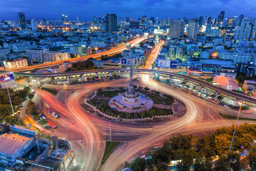 Fototapeta na wymiar Aerial view of highway junctions with roundabout. Bridge roads shape circle in structure of architecture and transportation concept. Top view. Urban city, Bangkok at sunset, Thailand.
