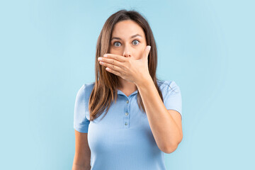 Surprised woman covers her mouth.