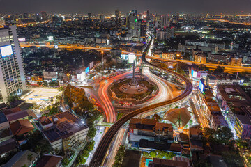 Fototapeta na wymiar aerial view of highway junctions with roundabout. Bridge roads shape circle in structure of architecture and transportation concept. Top view. Urban city, Bangkok at sunset, Thailand.